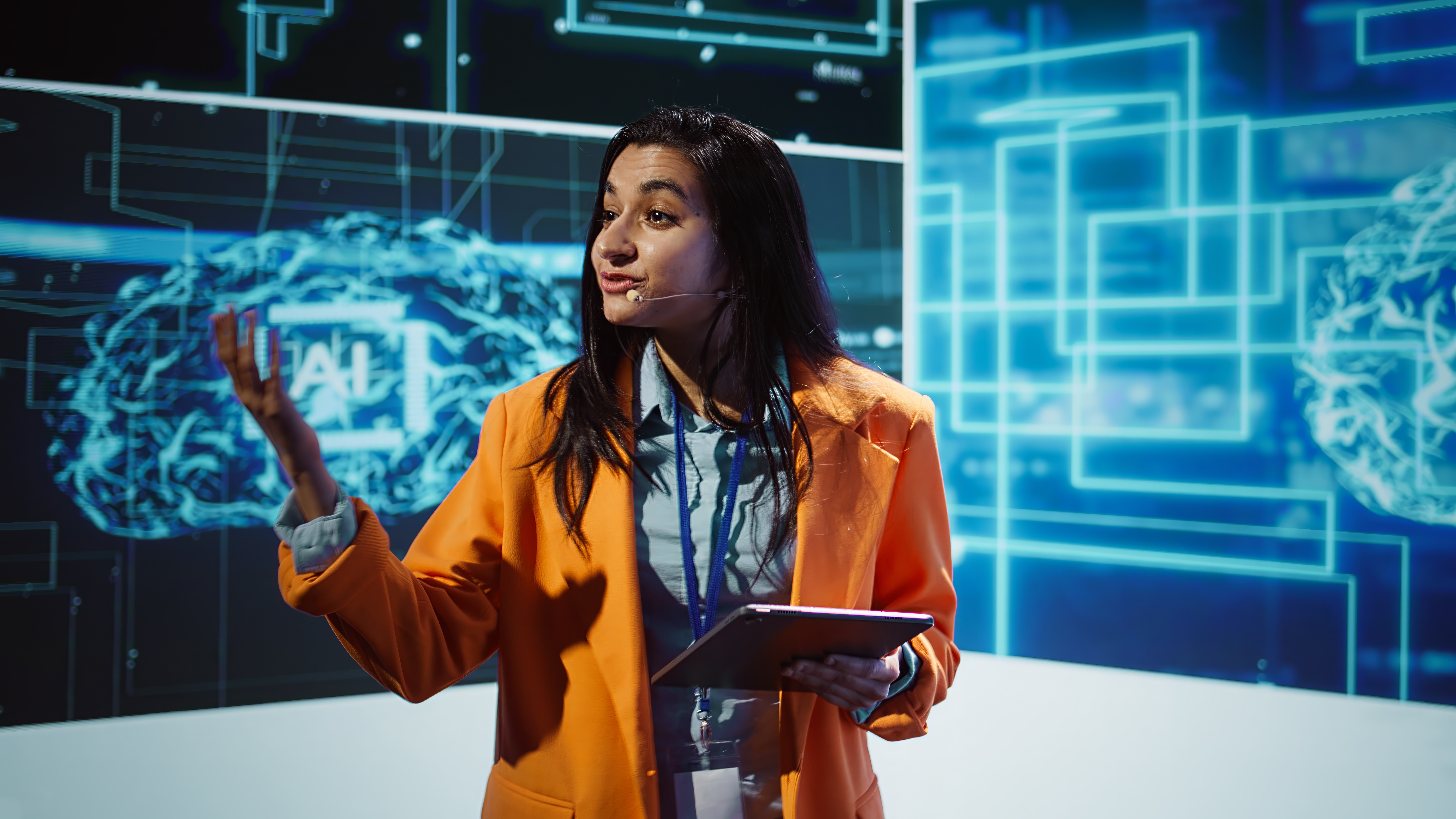 Women presenting in front of digital screen