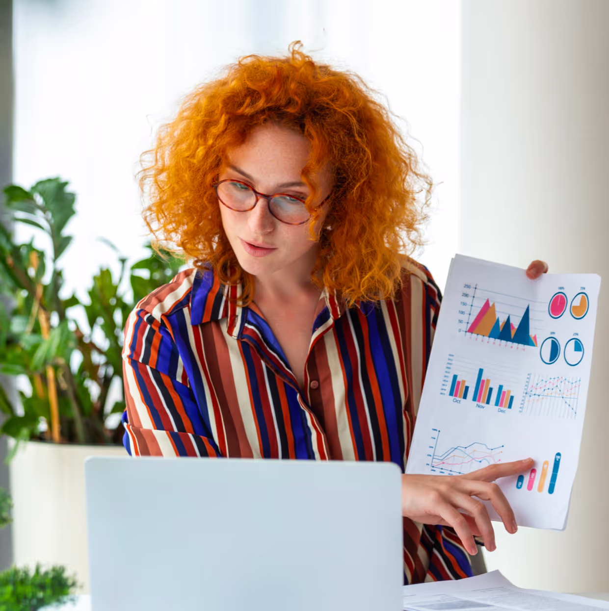Woman explaining graphs on laptop