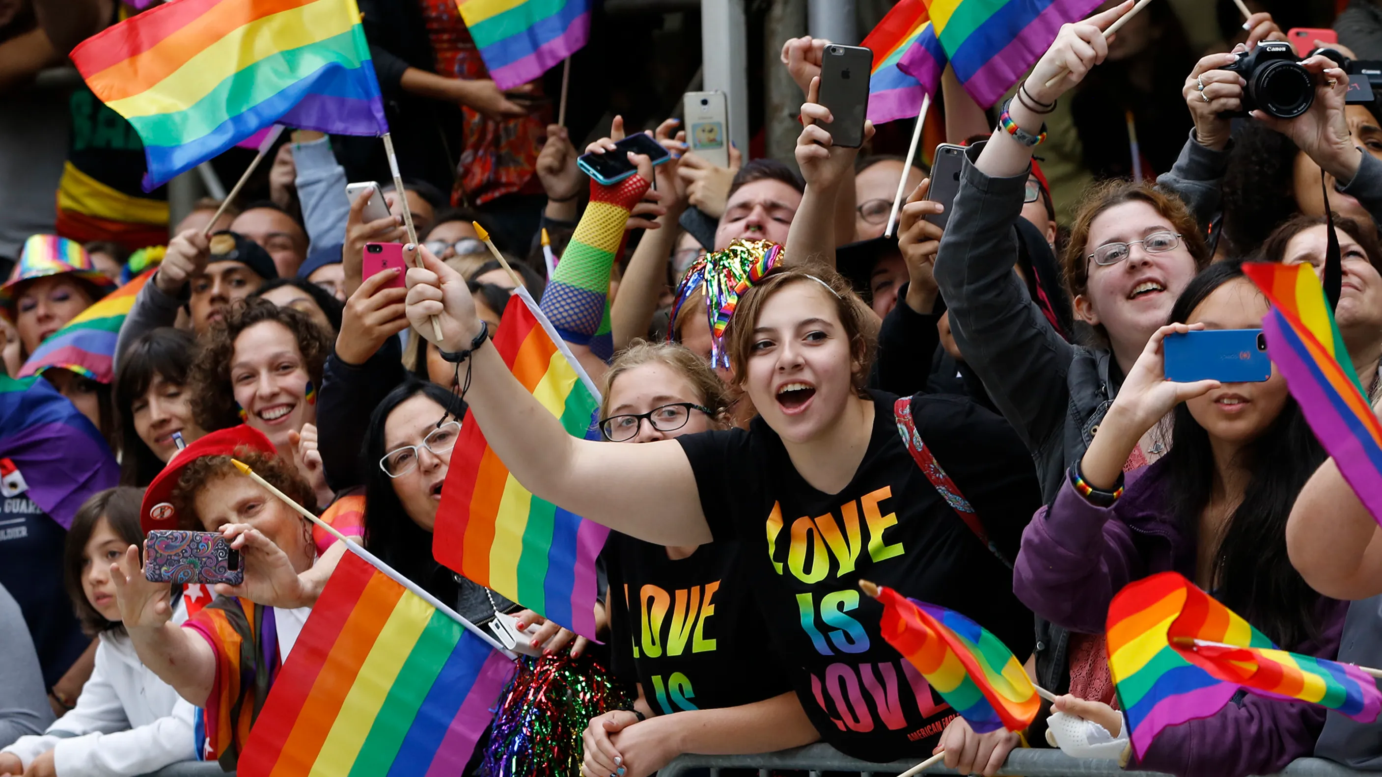 People waving pride flag