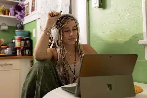 Girl with headphones using laptop