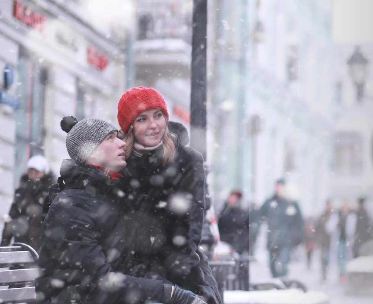 Couple enjoying snowfall